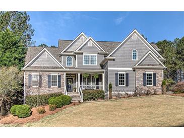 Charming two-story home with stone accents, beautiful landscaping, and a welcoming front porch at 304 Gilmer Ct, Canton, GA 30115