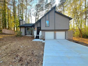 Charming two-story home with a two-car garage and unique architectural details at 3814 Whaley Ct, Snellville, GA 30039