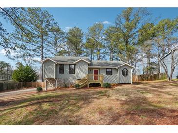 Charming gray home featuring a well-maintained lawn and a welcoming red front door at 3640 Barbara Dr, Douglasville, GA 30135