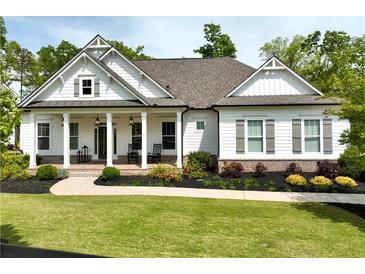 Charming craftsman-style home with a welcoming front porch and beautifully landscaped front yard at 305 Red Gate Ln, Canton, GA 30115