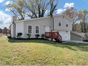 Charming two-story home with gray siding, a red deck, and a well-maintained lawn, perfect for curb appeal at 3690 Darrah Sw Way, Atlanta, GA 30331