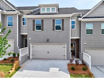 Beautiful townhouse with a two-car garage, gray brick, and charming curb appeal at 1347 Fern Ridge Ct # 29, Norcross, GA 30093