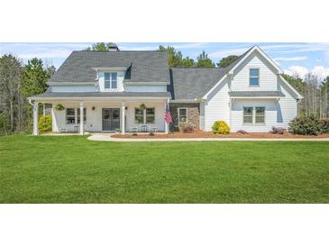 Charming two-story home featuring a landscaped front yard and inviting covered porch at 20 Tuscany Dr, Mansfield, GA 30055