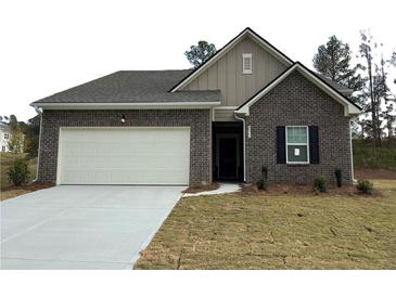 Charming brick home with a two-car garage and well-maintained front yard at 206 Silverton Dr, Dacula, GA 30019