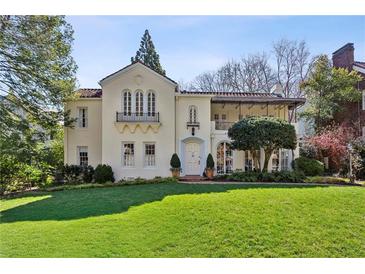 Elegant stucco home with manicured lawn, balcony, and classic architectural details at 41 Palisades Ne Rd, Atlanta, GA 30309