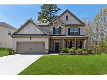Charming two-story home with a well-manicured lawn, inviting entrance and attached two car garage at 2096 Hamilton Lake Pkwy, Buford, GA 30519