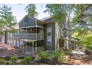Inviting condo with outdoor living space, lush landscaping, and wood accents at 606 Se Riverview Dr # 606, Marietta, GA 30067