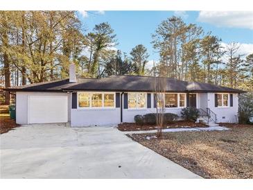 Charming ranch-style home with a brick facade, attached garage, and well-maintained front yard at 814 Bank St, Smyrna, GA 30080