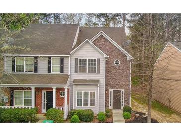 Charming townhome featuring stone and siding exterior with well-maintained landscaping and a welcoming entrance at 201 Creel Way, Atlanta, GA 30349