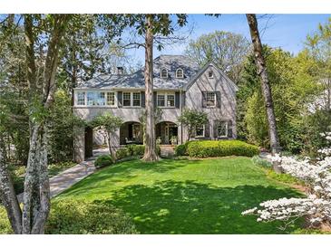 Charming two-story home with landscaped front yard and covered car port at 2628 Rivers Nw Rd, Atlanta, GA 30305