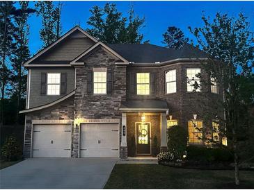 Charming two-story home featuring a stone facade, manicured lawn, and inviting front entrance at 406 Dunaway Ct, Grayson, GA 30017