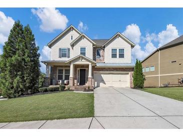 Charming two-story home with a manicured lawn, two-car garage, and inviting front porch at 5386 Bluestone Cir, Mableton, GA 30126