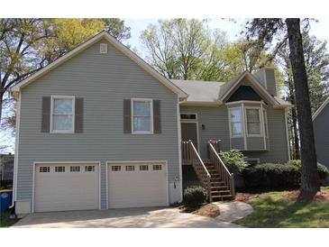 Charming two-story home with a well-maintained lawn, two car garage and inviting entryway at 2562 Kennesaw Springs Nw Ct, Kennesaw, GA 30144