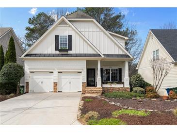 Charming two-story home featuring a well-maintained front yard and a two-car garage at 1814 Dupont Nw Ave, Atlanta, GA 30318