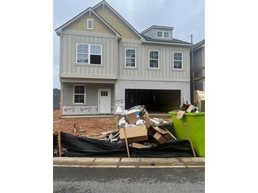 Two-story home with an unfinished garage and a yard in need of landscaping at 315 Lakeside Court, Canton, GA 30114