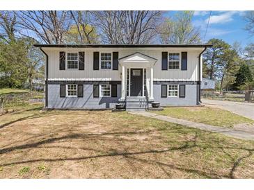 Charming two-story home featuring fresh paint, black shutters, and a welcoming front entrance at 6414 Bimini Dr, Forest Park, GA 30297