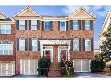 Charming two-story townhome with brick facade, black shutters, and inviting front entrances at 10918 Gallier St, Alpharetta, GA 30022