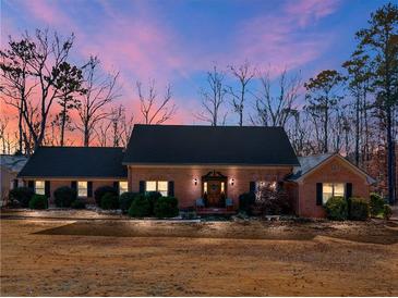 Charming brick home with well-maintained landscaping, mature trees, and inviting front entrance at 35 Tracechain, Stockbridge, GA 30281