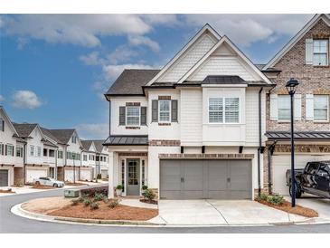 Charming two-story home featuring a gray two-car garage and inviting entrance at 525 Springer Nw Bnd, Marietta, GA 30060