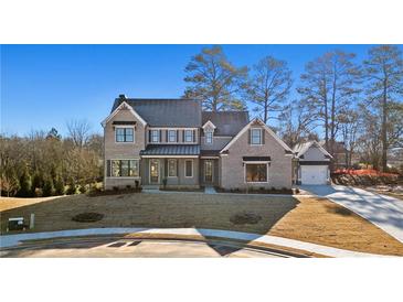 Stunning two-story brick home featuring an attached two car garage and manicured front lawn at 3812 Havenrock Dr, Marietta, GA 30066