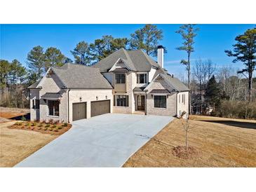 Stunning two-story brick home with a three-car garage and a spacious concrete driveway at 3820 Havenrock Dr, Marietta, GA 30066