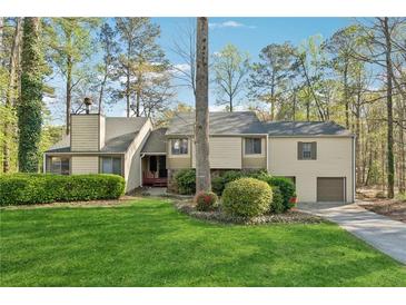 Charming home with mature trees and a well-manicured lawn, creating a welcoming curb appeal at 1870 Abercorn Way, Snellville, GA 30078