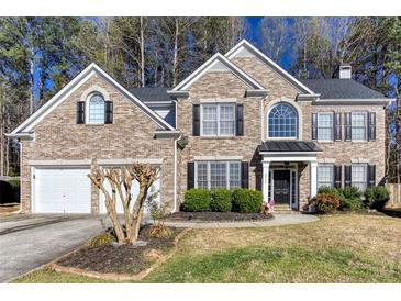 Charming brick two-story home with well-manicured lawn and attached two car garage at 2516 Woolwich Nw Ct, Acworth, GA 30101