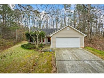 Charming single-Gathering home with a well-maintained lawn, two-car garage, and inviting front entrance at 300 Lakeside Dr, Covington, GA 30016