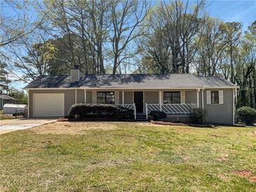 Charming single-story home featuring a covered porch, manicured landscaping, and attached garage at 31 Fox Creek Ct, Dallas, GA 30157