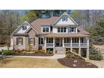 Beautiful two-story home featuring a welcoming front porch and manicured landscaping at 3227 Aviary Nw Ct, Acworth, GA 30101