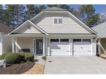Charming home featuring a two-car garage, neutral siding, and well-maintained landscaping at 4927 Magnolia Cottage Way, Acworth, GA 30101
