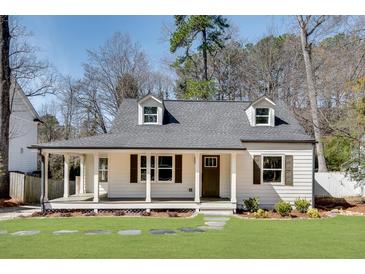 Charming home featuring a covered front porch, two dormers, and manicured lawn at 1861 Dyer Cir, Atlanta, GA 30341