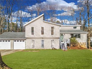 Charming two-story home with a two-car garage, green lawn, and inviting front entrance at 4519 Glenforest Ne Dr, Roswell, GA 30075