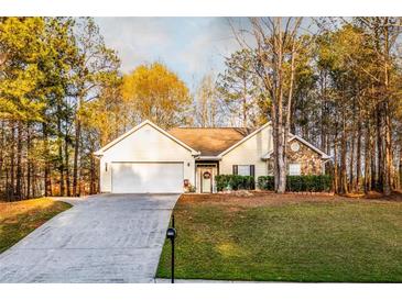 Charming single-Gathering home featuring a two-car garage, stone accents, and a well-manicured lawn at 531 Lindsey Way, Social Circle, GA 30025