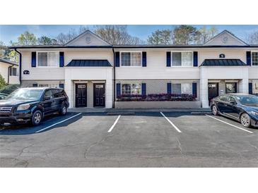 Exterior view of townhomes with parking spaces at 6940 Roswell Rd # 5B, Atlanta, GA 30328
