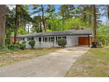 Charming one-story home with white brick, covered parking, and a spacious front yard at 2405 Clifton Springs Rd, Decatur, GA 30034