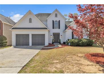 Charming two-story home with a two-car garage and a well-maintained front yard at 1055 Crabapple Parc Dr, Roswell, GA 30076
