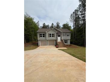 Charming two-story home with a two-car garage, stone accents, and a lush lawn at 95 Kendall Ln, Covington, GA 30014