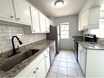 Updated kitchen featuring granite countertops, stainless steel appliances, and white cabinets at 3156 Nectarine Cir, Decatur, GA 30034