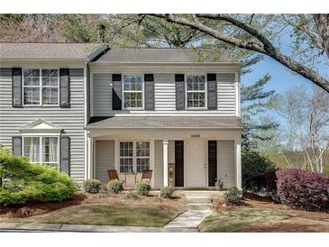 Charming two-story home with a well-manicured front yard and welcoming covered porch at 2306 Queen Anne Ct, Atlanta, GA 30350