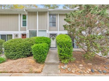 Charming townhouse exterior with neatly trimmed shrubs and a welcoming front entrance at 664 Powers Ferry North Se, Marietta, GA 30067