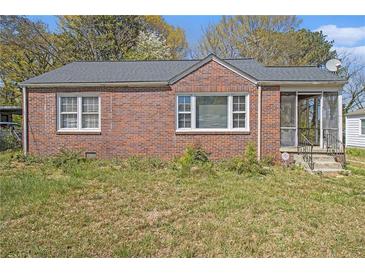 Charming brick home featuring a screened-in porch, perfect for enjoying the outdoors at 854 Slaton St, Forest Park, GA 30297
