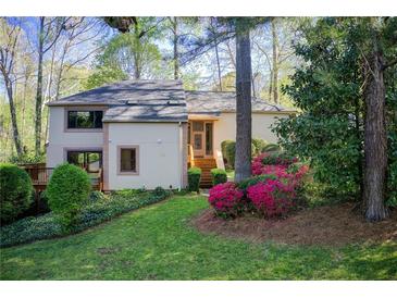 Charming two-story home featuring lush landscaping, mature trees, and a welcoming entrance at 4983 Odins Way, Marietta, GA 30068