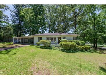 Charming single-story home with a well-manicured lawn and a convenient carport at 1920 W Forrest Ave, Atlanta, GA 30344
