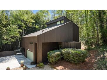 Unique modern home featuring a striking exterior and lush surrounding landscape at 2683 Fleur De Lis Pl, Atlanta, GA 30360
