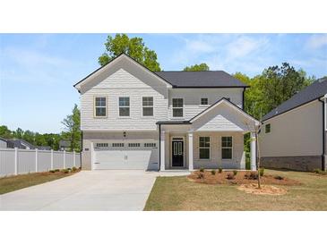 Charming two-story home with white brick accents and a two-car garage in a desirable neighborhood at 13562 Whitman Ln, Covington, GA 30014