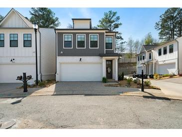 Charming two-story home with a modern exterior, featuring a gray facade and a spacious two-car garage at 8The07 Stickley Oak Way, Woodstock, GA 30189