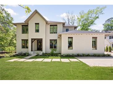 Charming home with a manicured lawn, eye-catching architecture, and lovely front yard landscaping at 1068 Moores Mill Nw Rd, Atlanta, GA 30327