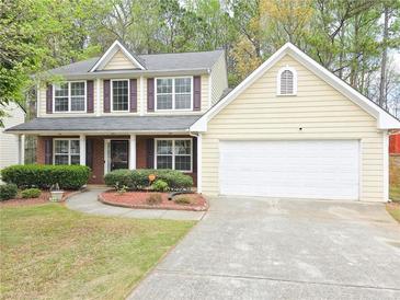 Charming two-story home with a well-maintained front lawn and attached two car garage at 1972 Ashwood Grove Dr, Snellville, GA 30078