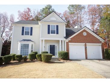 Charming two-story home with a two-car garage, well-maintained landscaping, and a welcoming front entrance at 3936 Toccoa Falls Dr, Duluth, GA 30097